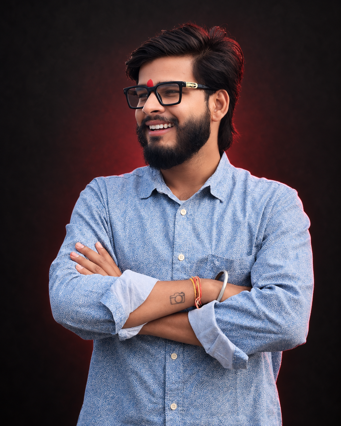 Aman Sharma, founder of Wild Frame Productions, smiling with his arms folded